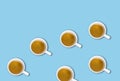 Minimalist pattern with a top view of a group of coffee cups on a light blue pastel table