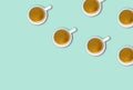 Minimalist pattern with a top view of a group of coffee cups on a light green pastel table