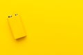 Minimalist photo of blank nine-volt battery on yellow background with copy space