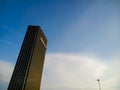 Minimalist photo of a building and a street light on a bluish white sky, daytime, morning