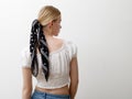 Minimalist photo, Fashionable girl in stylish summer things . View from the back. Earrings, a ring , a scarf on her head