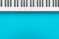 Minimalist photo of midi keyboard over turquoise blue background