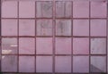 Minimalist photography of a pink door with metal panels and mesh