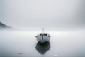 Minimalist picture of a small boat on a partially frozen lake. Winter landscape.