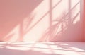 Minimalist pink studio interior with soft shadows from plants and window grid. Empty space for product placement or backdrop. Royalty Free Stock Photo