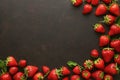 Minimalist presentation of strawberries on textured slate surface