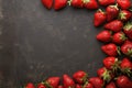 Minimalist presentation of strawberries on textured slate surface