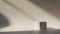 Minimalist Product Display Cube with Dramatic Diagonal Light and Shadow Play on a Neutral Background Royalty Free Stock Photo
