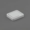 A minimalist, rectangular, white light switch with rounded edges sits on a plain gray Royalty Free Stock Photo