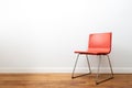 Minimalist Red Chair Against a White Wall Royalty Free Stock Photo