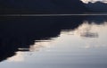 Minimalist reflection of sunset clouds, mountains in clear the water of Lulealven river in Saltoluokta in Sweden Lapland. Royalty Free Stock Photo