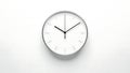 Minimalist round clock on white wall showing 10:02 time silver m Royalty Free Stock Photo
