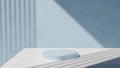 Minimalist rounded podium on the marble table with soft strip shadow