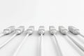 Minimalist row of white Ethernet cables plugged into a neutral wall representing clean network setups and organized telecom con