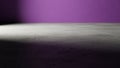 Minimalist scene with concrete floor and vibrant purple wall with dramatic lighting Royalty Free Stock Photo