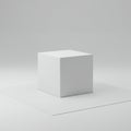 A minimalist scene featuring a white cube placed on a similarly colored square platfo Royalty Free Stock Photo