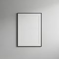 A minimalist setting displays a blank white canvas in a thin black frame, mounted on a Royalty Free Stock Photo