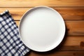 Minimalist setting White plate tray on wooden tablecloth, top view