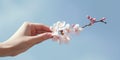 A minimalist shot of a hand reaching out to touch a delicate cherry blossom, symbolizing the fleeting beauty of life