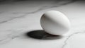 Single white egg on marble surface with soft shadow effect Royalty Free Stock Photo