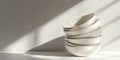 Minimalist Stack of White Ceramic Bowls with Soft Shadows on Neutral Background in Sunlight Royalty Free Stock Photo