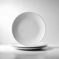Minimalist stack of white ceramic plates isolated on white background Royalty Free Stock Photo