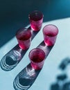 Minimalist still life of cranberry red glasses.