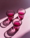 Minimalist still life of cranberry red glasses.