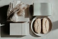 Minimalist still life with decorative boxes, fabric, and cookies on a plate Royalty Free Stock Photo