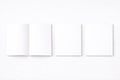 Three blank white rectangular papers displayed on a light gray surface Royalty Free Stock Photo