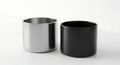 Minimalist Still Life - Two Cylindrical Cups, Silver and Black, on White Background Royalty Free Stock Photo