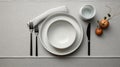 Minimalist Still Life: White Dinner Plate With Forks And Knives On Gray Table