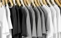 Minimalist Style: White, Gray, and Black T-Shirts Hanging on a Hanger, a Fashion Showcase of Casual and Timeless Apparel
