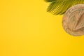 Minimalist summer flat lay with, palm leaves and panama hat on yellow Royalty Free Stock Photo