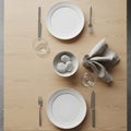 A minimalist table setting features a light wood surface with two white plates, each accompanied by Royalty Free Stock Photo