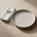 A minimalist table setting features a round, beige ceramic plate placed on a light Royalty Free Stock Photo