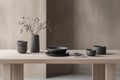A minimalist table setting featuring dark pottery and dried flowers in a serene environment Royalty Free Stock Photo