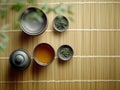 Minimalist tea ceremony setup with green tea, ceramic teaware, and bamboo mat background Royalty Free Stock Photo