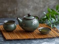 Minimalist tea ceremony setup with green tea, ceramic teaware, and bamboo mat background Royalty Free Stock Photo