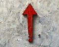 Minimalist thick red arrow pointing down on light grey canvas with subtle shadow, conveying descent Royalty Free Stock Photo