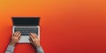 Minimalist Top View of Man's Hand Typing on Modern Laptop on Gradient Red Background Royalty Free Stock Photo