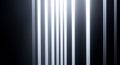 A minimalist view of vertical white light stripes against a dark background in a simple composition Royalty Free Stock Photo