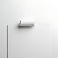 Minimalist wall-mounted cylindrical object in a plain setting Royalty Free Stock Photo
