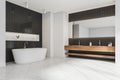Minimalist white and black bathroom space with wooden vanity. Corner view Royalty Free Stock Photo