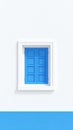 Minimalist white building facade with bright blue window shutters and contrasting stripe Royalty Free Stock Photo