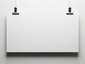 Minimalist white canvas with black clips hanging on a white wall Royalty Free Stock Photo