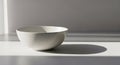 Minimalist White Ceramic Bowl with Dramatic Window Shadows Royalty Free Stock Photo