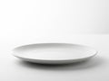 Minimalist white ceramic plate on plain background Royalty Free Stock Photo