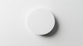Minimalist white circular object casting soft shadow on clean white background Royalty Free Stock Photo
