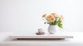 A minimalist white coffee table, adorned with a vibrant vase of orange flowers and a soothing cup of coffee, exuding a sense of